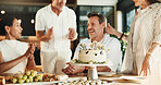 Happy, friends and candles in house with birthday cake, bonding together or applause for milestone. Mature people, clapping and special day celebration in dining room with dessert, support and party.