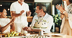 Happy, man and friends in home with birthday cake, bonding together and applause for age milestone. Mature people, clapping and special day celebration in dining room with dessert, support and party.