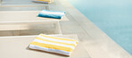 Empty, chair and towel at resort with swimming pool, guest comfort and reserved seating on holiday. Fabric, poolside and sun lounger at retreat with amenity, sunbathing and hospitality on vacation