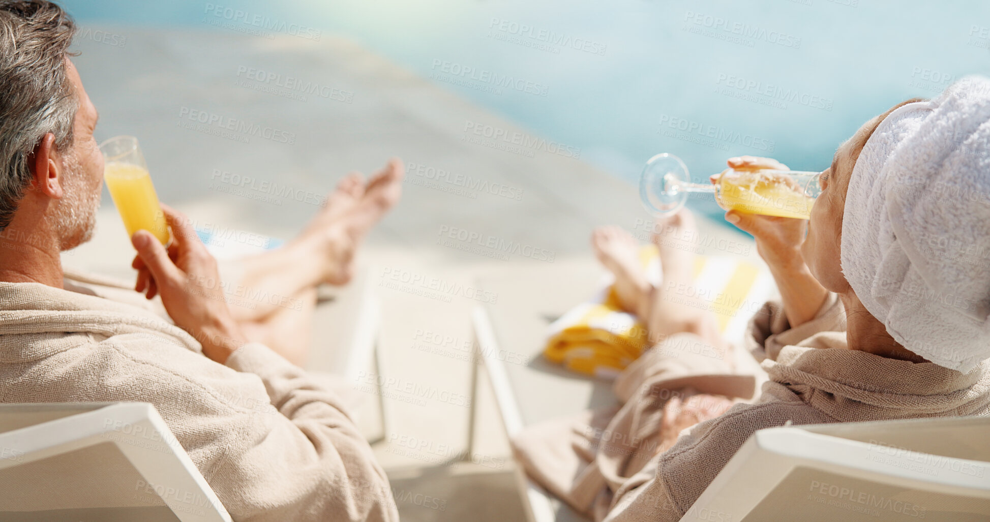Buy stock photo Drinks, couple and relax at swimming pool on vacation, summer break and bonding together on getaway. Poolside, mature man and woman with mimosa cocktail, holiday and back at luxury resort with love