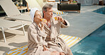 Drinks, couple and relax at swimming pool on summer vacation, break and bonding together on getaway. Poolside, mature man and woman with mimosa cocktail, holiday or outdoor at luxury resort with love