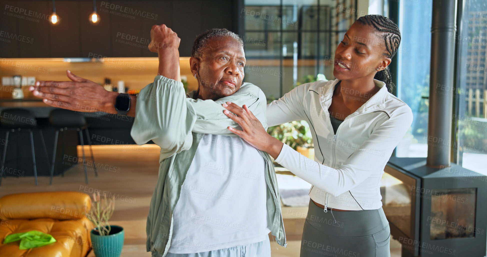Buy stock photo Personal trainer, stretching and health with black women in home for help, geriatric fitness and support. Exercise instructor, physical therapy and warm up with senior person for low impact workout