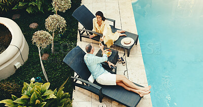 Buy stock photo Couple, champagne and cheers at swimming pool on vacation, relax or anniversary celebration for love. Mature man, woman and toast with drinks on holiday, smile and romance at luxury resort from above