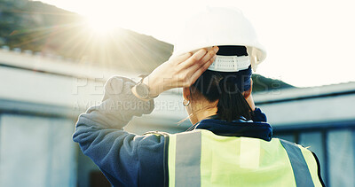 Buy stock photo Engineer, woman and helmet at construction site with safety rules, injury prevention and inspection. Back, flare or person outdoor with PPE for protection, engineering supervisor or building project.