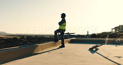 Buy stock photo Technician, man and thinking at construction site with rooftop view, arms crossed and project plan. Confident, electrician or person in city space with building evaluation, infrastructure or vision