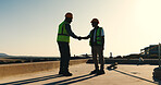 Handshake, success and construction worker team on rooftop for completion, building or development. Shaking hands, people and celebrate outdoor for home renovation, engineering and deal at property