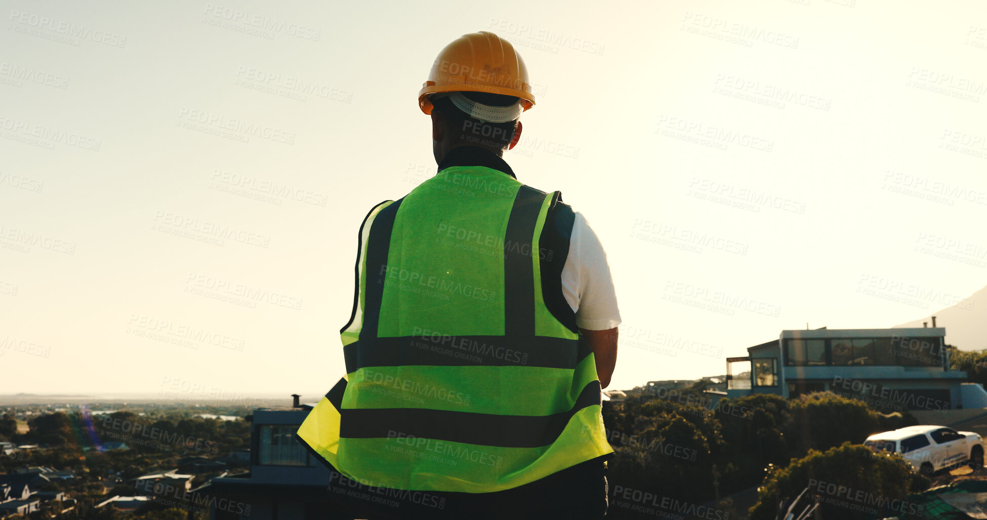 Buy stock photo Builder, man and thinking at construction site with city view, brainstorming or planning for project. Back, worker and person outdoor in urban space with building evaluation, infrastructure or vision