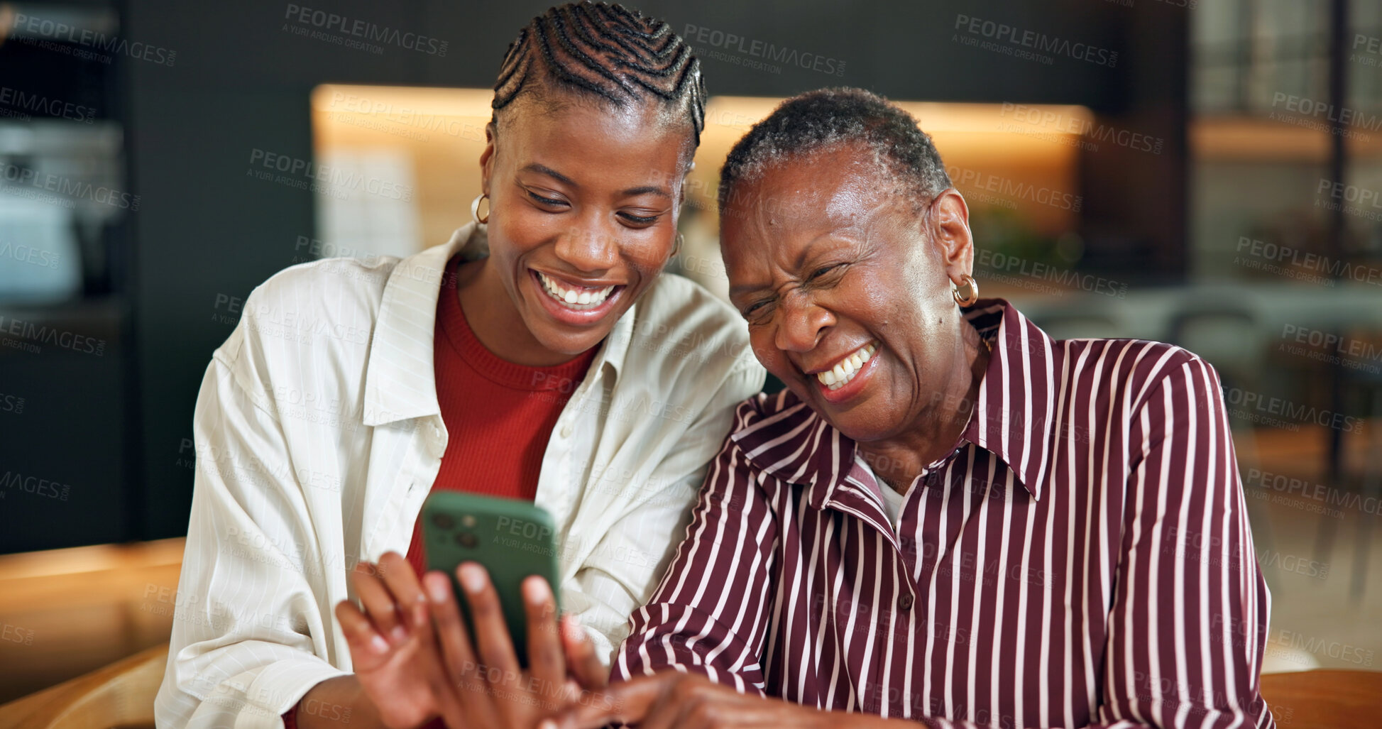 Buy stock photo Senior mother, laughing and woman with phone in home, entertainment or watching video with daughter. Family, online and bonding with elderly parent, happy and black people with mobile for funny film