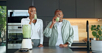 Buy stock photo Black family, drinking and glass at house with smoothie, healthy drink and green juice for diet. Old woman, daughter and blender in kitchen with protein shake, organic ingredients and detox beverage