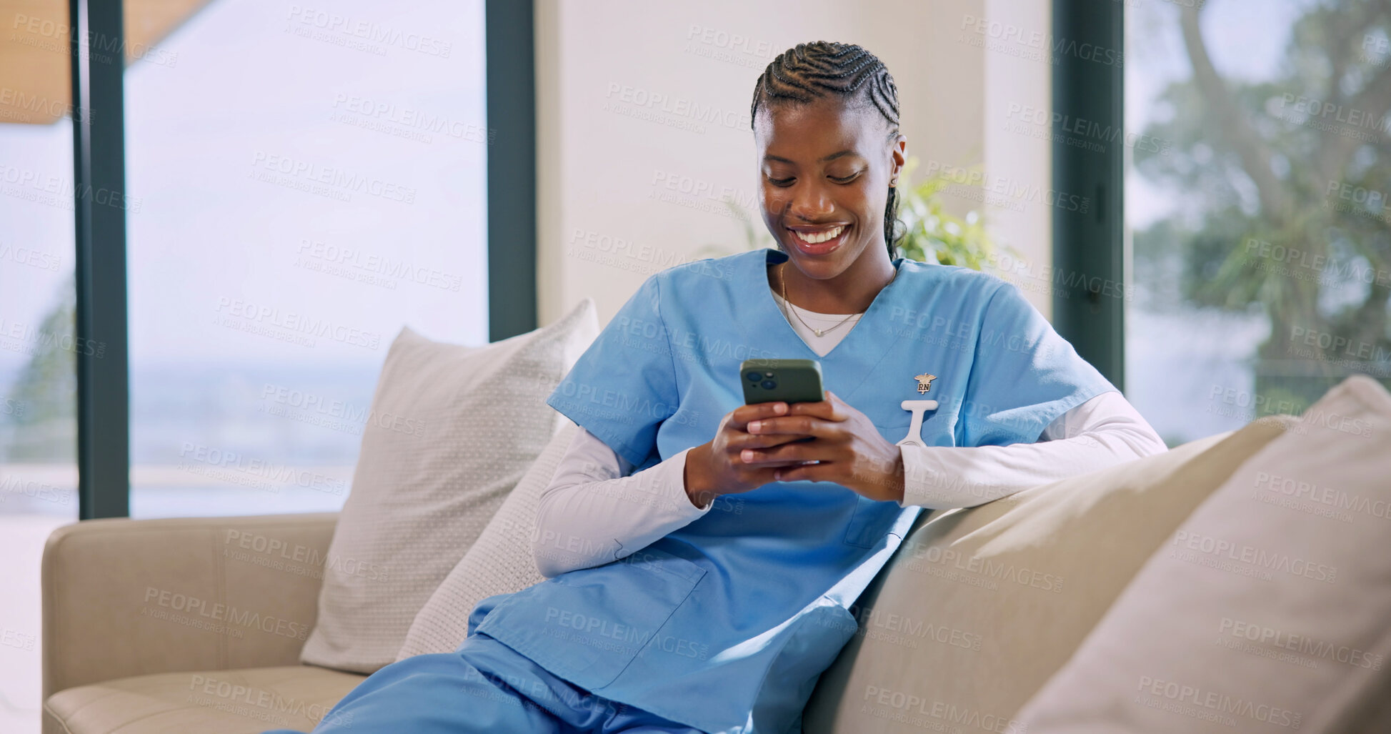 Buy stock photo Happy, caregiver and woman in nursing home with phone, text message or good news for patient health. Nurse, black person and smile on couch with tech, medical research or check schedule on work break