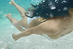 Woman, swimming or underwater with bikini for outdoor vacation, travel or beach holiday in nature. Female person, traveler or swimmer in sea or swimsuit for tropical adventure or journey in ocean