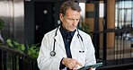 Mature, man and doctor with tablet in hospital for medical research, patient history or schedule. Male person, healthcare worker or checking app with technology for information or online appointments