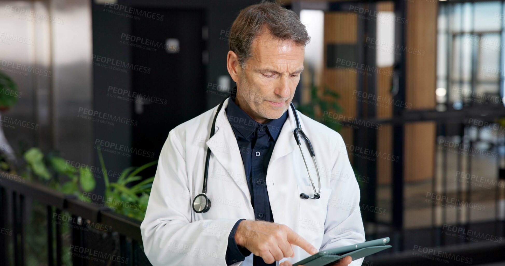 Buy stock photo Mature, man and doctor with tablet in hospital for medical research, patient history or schedule. Male person, healthcare worker or checking app with technology for information or online appointments