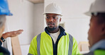 Engineer, man and talk at construction site with team, planning renovation and listen to technician. Supervisor, people and advice in building for engineering, project and feedback from electrician.