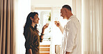 Happy, couple and toast in hotel room with champagne, anniversary celebration and romantic getaway. Mature people, smile and cheers in holiday accommodation with drink, relationship milestone or love