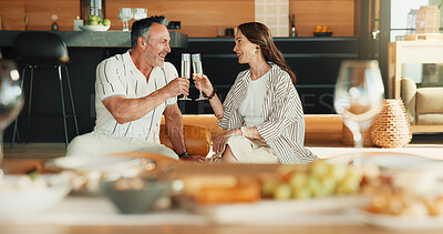 Buy stock photo Mature, couple and toast in home with champagne, smile and celebration of relationship anniversary. Happy, people and cheers in living room with alcohol drink, romantic date or commitment to partner.