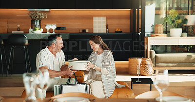 Buy stock photo Love, gift giving and mature couple in home, Christmas or gratitude for holiday celebration. Man, woman or appreciation with xmas present exchange, care or bonding together with happy partner on sofa