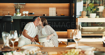 Buy stock photo Love, hug and couple with gift in home, valentines day or gratitude for anniversary celebration. Man, mature woman and embrace with present appreciation, care or marriage milestone at romantic dinner