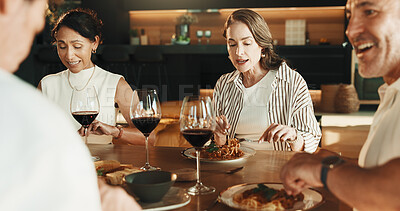Buy stock photo Friends, lunch and red wine in house with conversation, relax together and gossip on weekend break. Happy, mature people and spaghetti food in dining room with alcohol drink, discussion and bonding.