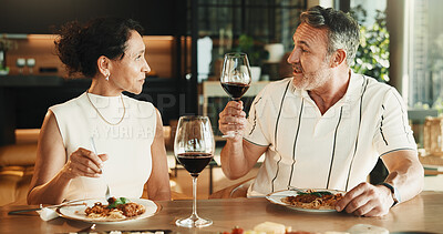 Buy stock photo Couple, dinner and chat with wine in house, bonding together and relax with partner on special day. Anniversary, meal and mature people with alcohol, happiness and connection with spouse in home
