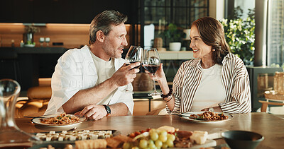 Buy stock photo Couple, food or cheers with wine for loyalty, relationship milestone or anniversary meal in home. Happy man, mature woman and toast with alcohol for appreciation, marriage promise and lunch date