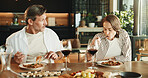 Couple, lunch and conversation at dining table with wine, relax together and gossip on weekend break. Mature people, date and eating spaghetti food in home with alcohol drink, bonding and discussion.