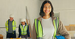 Electrician, portrait and woman with helmet in building, safety or confident for career development. Maintenance, team and happy people with hard hat, protection and technician on construction site