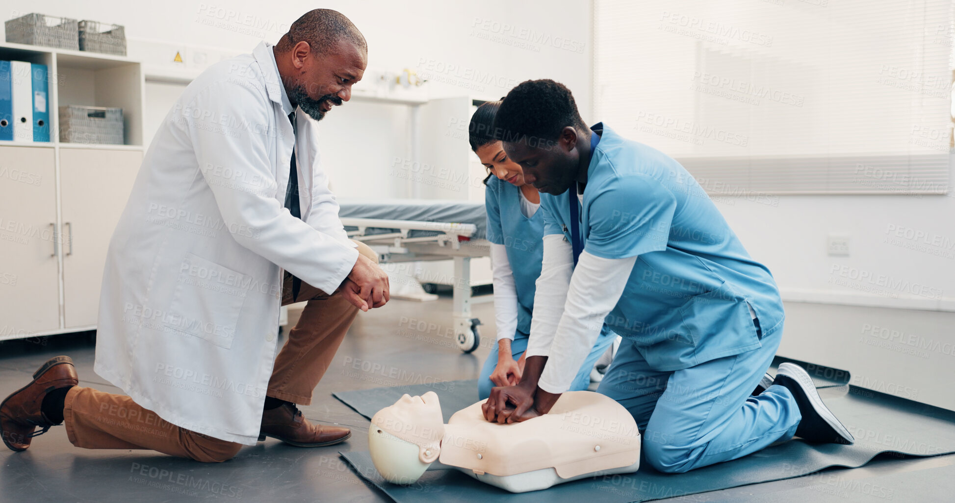 Buy stock photo Healthcare, team or dummy in training for cpr, compression technique or residency practical. Man, physician or resident doctors with mannequin, life saving procedure or clinic simulation in first aid