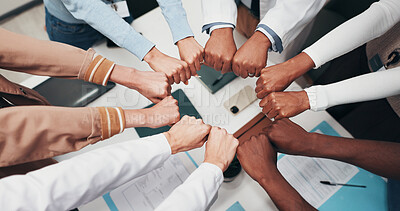 Buy stock photo People, diversity and meeting with fist bump for medical mission, teamwork or unity together. Top view, group or healthcare workers with hands in solidarity for community wellness campaign in office