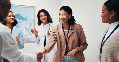 Buy stock photo Doctor, meeting and happy woman with handshake for winning, team success or promotion in hospital. Female person, smile or shaking hands with colleagues or applause for congratulations in clinic