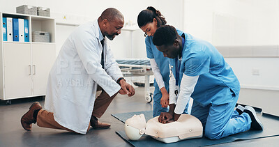 Buy stock photo Medical, team and dummy in training for cpr, chest compression and blood flow maintenance in clinic. People, doctor and nurses with mannequin, simulation and life saving procedure for cardiac arrest