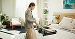 Woman, packing and bedroom with suitcase in hotel for holiday, weekend or vacation in resort. Female person, travel or bag with clothing in bed for getaway, hospitality or accommodation in retreat