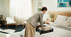 Woman, packing and suitcase at house for travel, preparation and clothing for holiday adventure. Female person, sorting and luggage in bedroom for tourism, apparel and getting ready for vacation trip