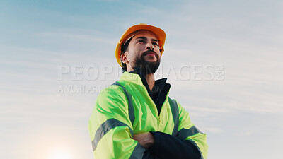 Buy stock photo Construction worker, thinking and man with arms crossed, outdoor or pride for property development. Sky, mockup space and happy person with helmet, low angle and reflection for renovation project