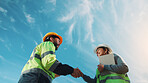 Team, handshake and happy people with tablet on construction site, low angle and renovation project. Sky, mockup space and colleagues with tech for property development, collaboration or architecture