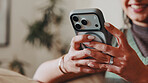 Woman, hands and relax in home with phone, social media and latest celebrity gossip in online news. Person, mobile and smile in living room for funny article, connectivity and check text notification