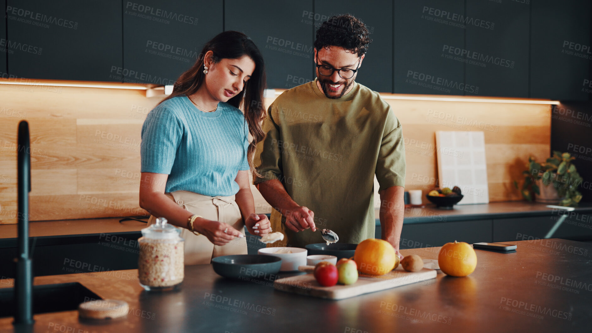 Buy stock photo Couple, breakfast and yogurt in kitchen for health, nutrition or food preparation with happiness. Muesli, man and woman with morning diet in home for help, wellness lifestyle and partner support