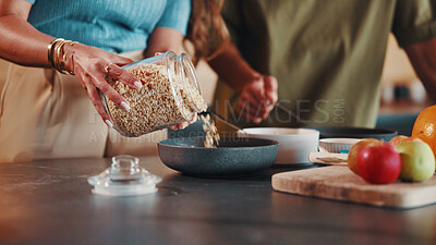 Buy stock photo Couple, hands and oats in kitchen with breakfast bowl, fruits and gut health benefits for wellness. People, dating and meal prep together in home with cereal grain, food and nutrition for morning.