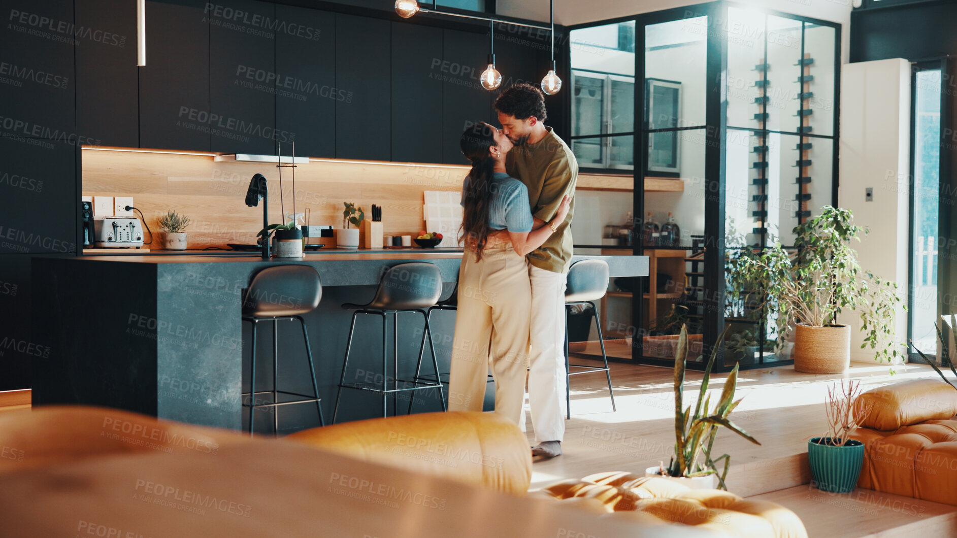 Buy stock photo Couple, hug and kiss in house with love, soulmate connection and quality time for bonding together. Married people, embrace and affection in living room with loyalty, romantic partner and commitment.