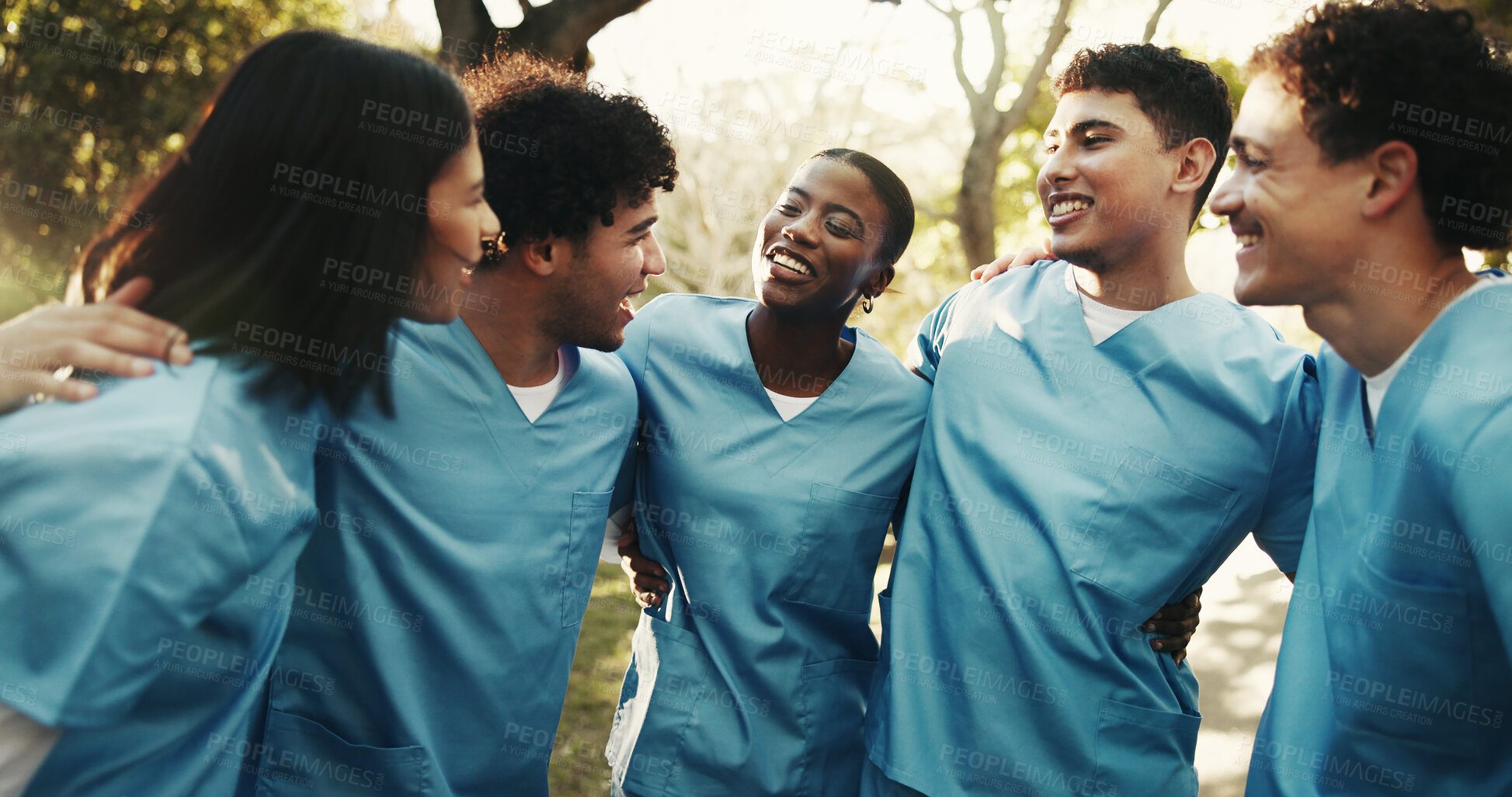 Buy stock photo Happy, friends or nursing student outdoor with hug, connection or peer bonding in medical education. Companion, people or interns with huddle, support embrace or group unity in healthcare residency.