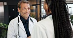 Doctor, man and team in hospital with smile, collaboration and good news for patient rehabilitation. Happy, healthcare manager and people in clinic with positive feedback, medical advice or optimism.