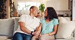 Sofa, couple and smile with holding hands for love, connection and bonding together with affection. Mature people, man and woman with support for commitment, trust and care in relationship in home