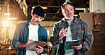 Carpenter, team and writing in workshop with clipboard, tablet and mentorship for timber production. Manager, men and discussion in warehouse with tech, taking notes and advice from carpentry mentor.