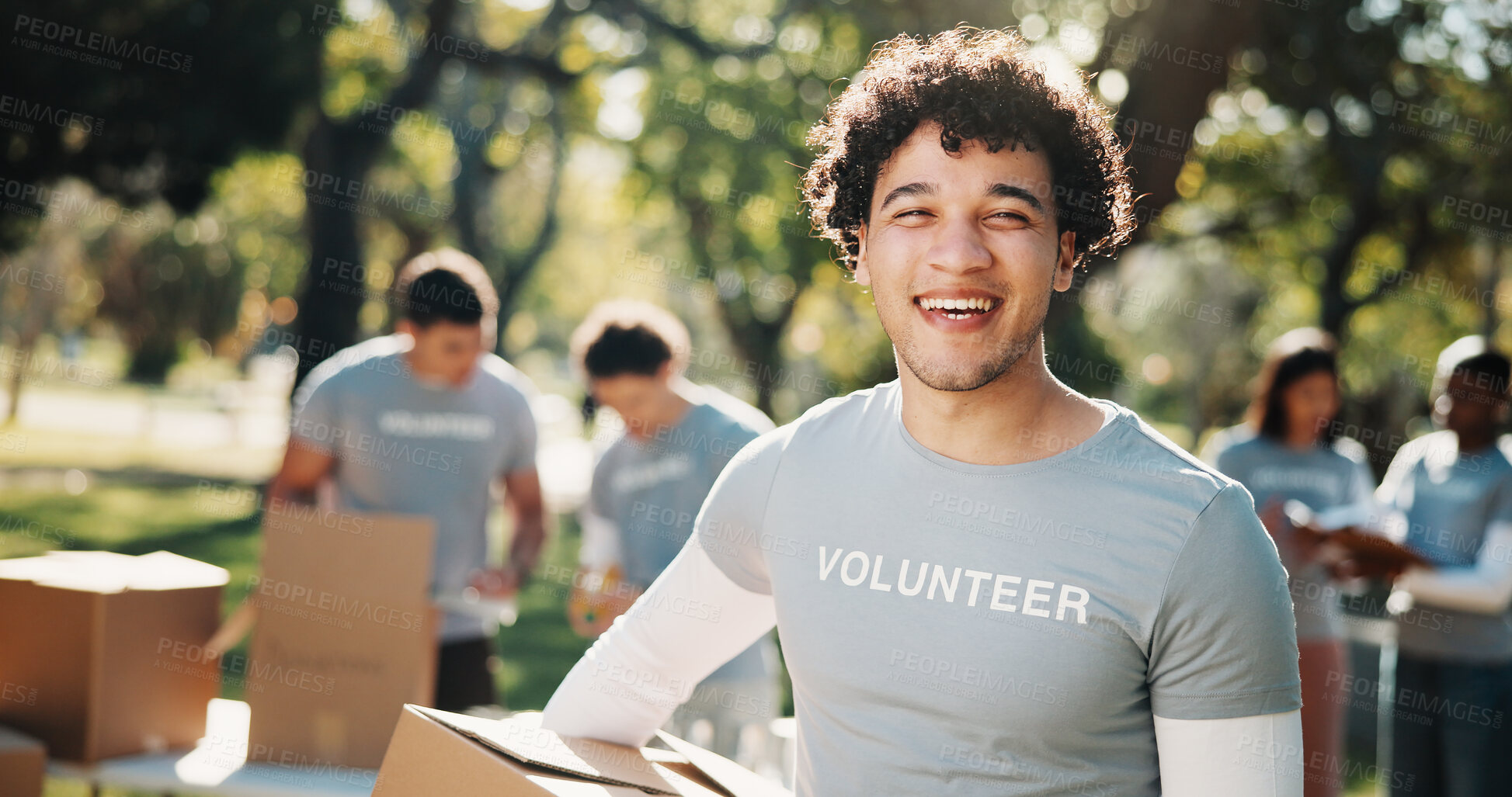 Buy stock photo Volunteer, portrait and man with box in park for outreach program, community service and welfare. Happy, outdoor and person with package for food drive, donation and charity event for ngo campaign