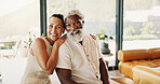 Love, happy and portrait with interracial couple in home for bonding, connection and support. Commitment, relax and care with senior man and woman in living room in house for rest and weekend break