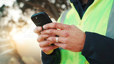 Buy stock photo Construction worker, online and hands with phone, outdoor and communication with contact on website. Low angle, property development and person with mobile, message and project update on social media