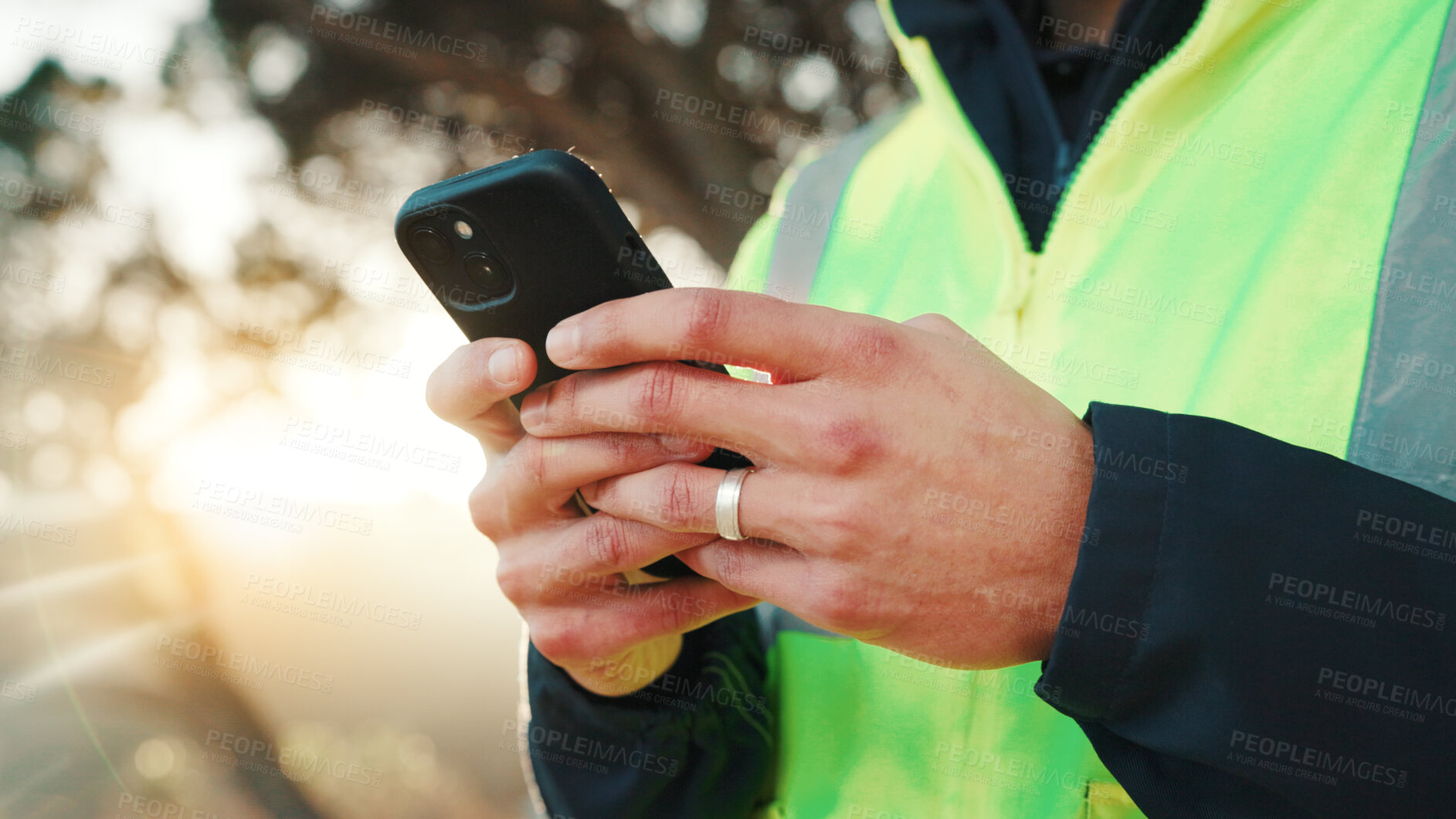 Buy stock photo Construction worker, online and hands with phone, outdoor and communication with contact on website. Low angle, property development and person with mobile, message and project update on social media