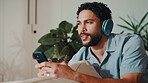 Man, thinking and headphones or phone on home sofa for streaming music, podcast or subscription. Happy, audio playlist and male person relax on couch with mobile app, technology and sound online