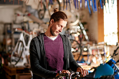 Buy stock photo Business, bicycle and man in workshop, inspection and fix with skills, startup and maintenance. Shop owner, entrepreneur or employee in store, merchandise and cyclist with sustainability or engineer