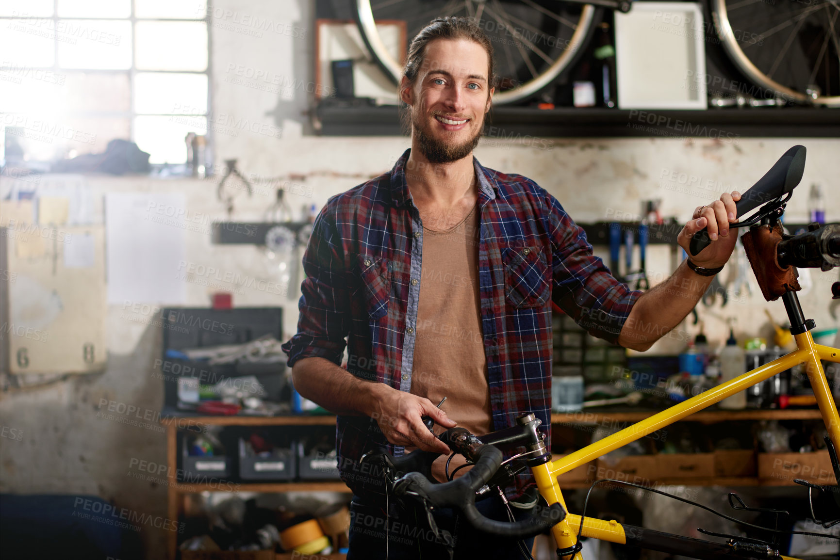 Buy stock photo Portrait, workshop and man with startup, bike repair and maintenance with pride, smile and confidence. Person, entrepreneur and business owner with restoration expert, happiness and professional